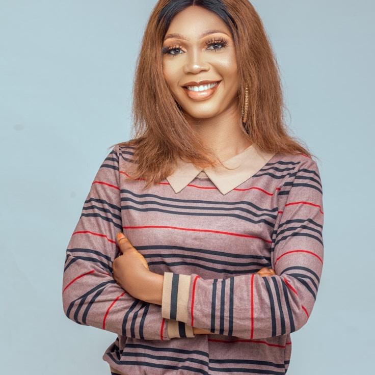 Alex Chen, Lead Design Curator at Primrose & Co., reviewing corporate floral arrangements